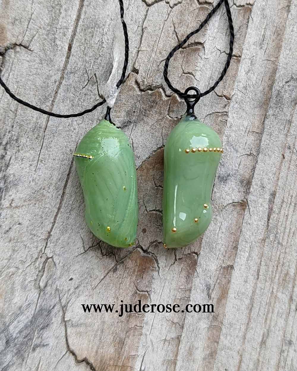 Side view of actual Monarch chrysalis next to a Jude Rose replica of Monarch chrysalis in glass and 24k gold