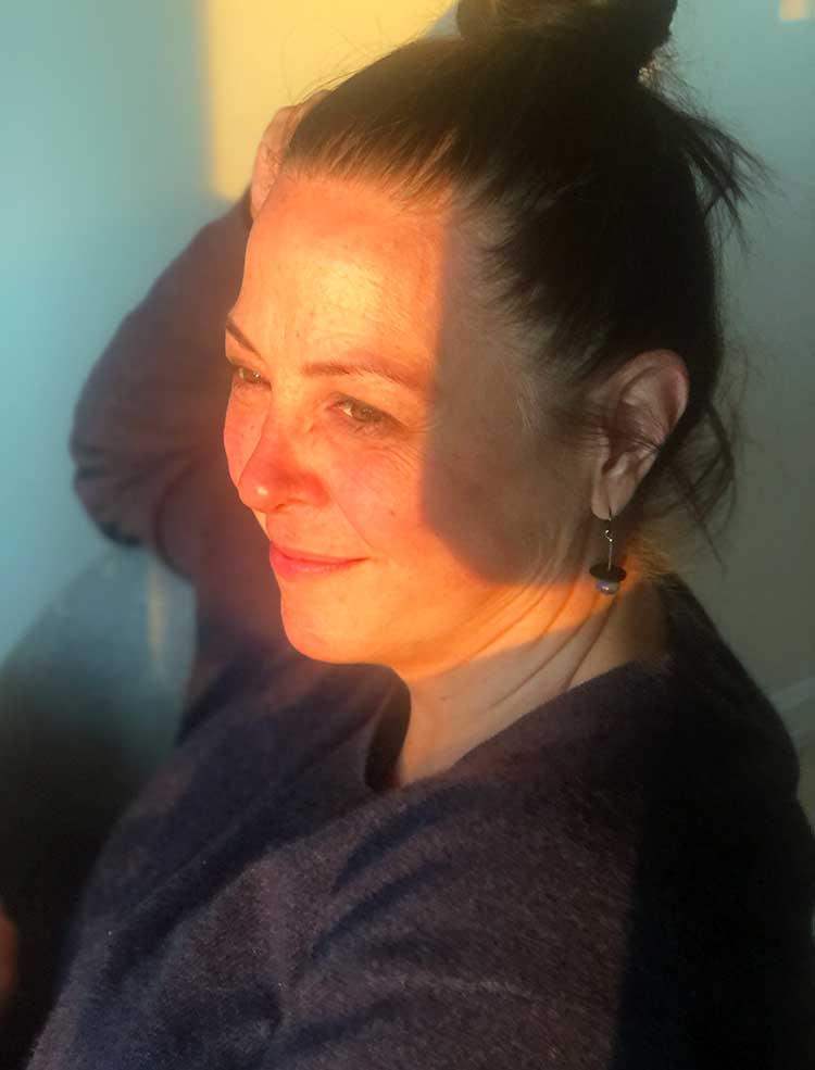 Monarch chrysalis artist Jude Rose of Ancient Child Studio looking at sunset.