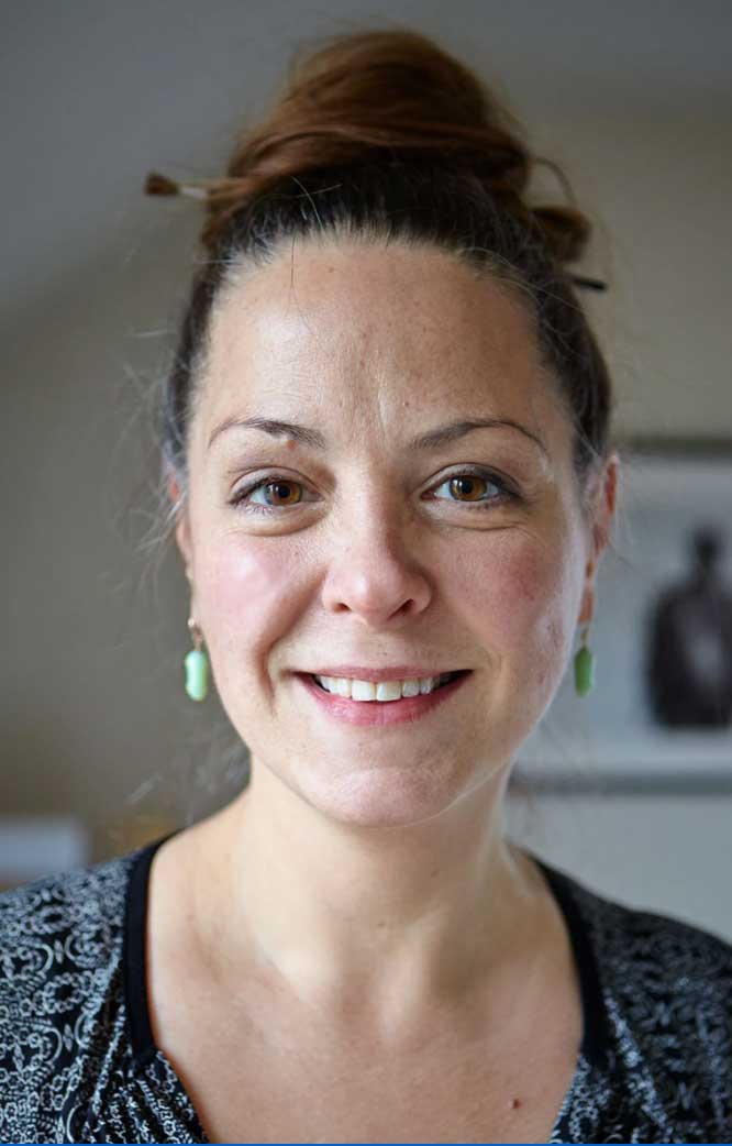 Glass artist Jude Rose wearing chrysalis earrings